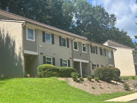 Shows a front image of the front of a small brick house
